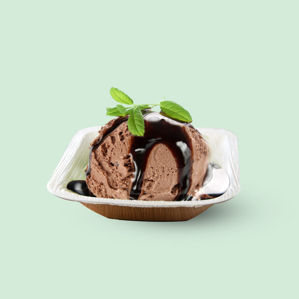 Chocolate ice cream with mint leaves served in a 5 oz Compostable Palm Leaf 4 Inch Square Bowl.
