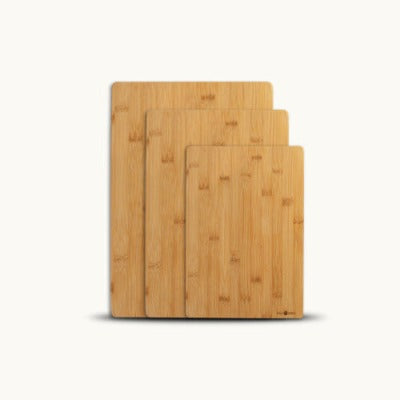 Three bamboo cutting boards on a white background.