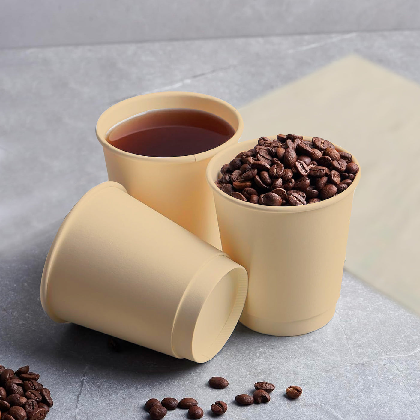 Two cups of coffee and beans on a table, with 8oz Disposable Coffee Cups made from Bagasse.