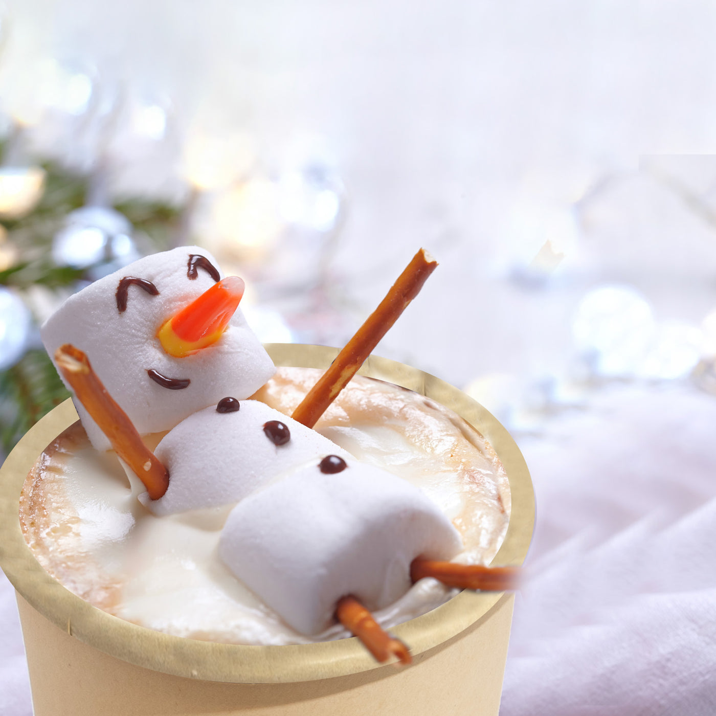 A 12oz cup of hot chocolate cup and a snowman placed inside it