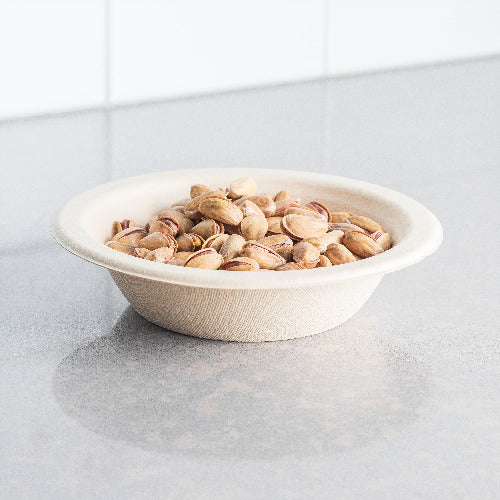 Assorted nuts in a compostable 12 oz bowl placed on a counter.