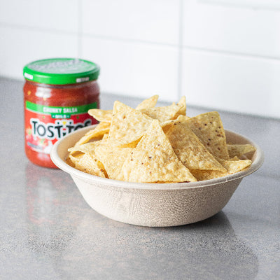 A 34oz compostable bowl filled with crispy chips and accompanied by a jar of salsa.