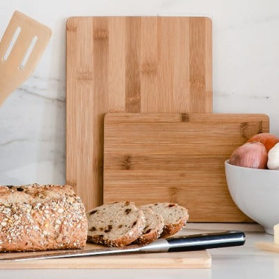 Three-piece bamboo cutting board set ideal for chopping and slicing tasks.