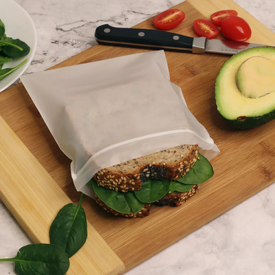 Breadsandwich placed on a Compostable sandwich resealable bags, measuring 7.25" X 6".