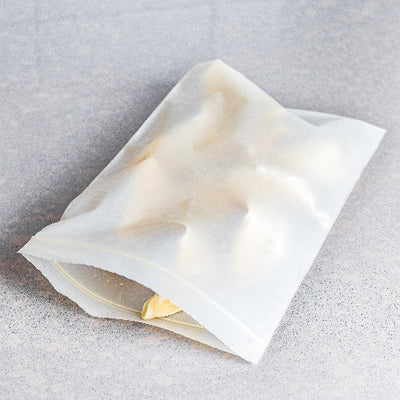Food in a compostable quart resealable bag placed on a table.